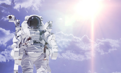 Wall Mural - creative concept of happy astronaut fly high in the sky with clouds, relax chill and dream idea elem