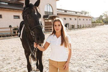 Wall Mural - Beautiful woman with horse in countryside