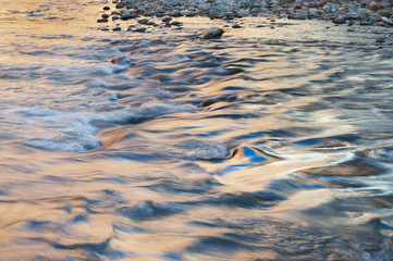 Landscape of the Virgin River captured with motion blur and illuminated with reflected color from sunlit summer trees and cliff, Zion National Park, Utah, USA