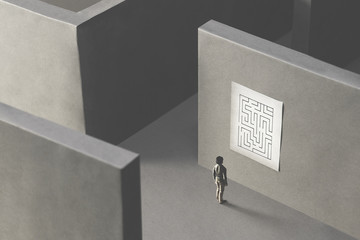 Wall Mural - man lost in a complex maze, observing the map to find the way out