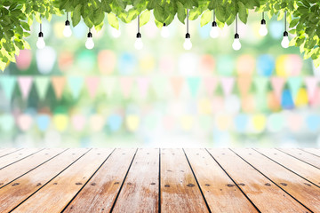 Empty wooden table with party in garden background blurred.