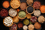 Legumes, a set consisting of different types of beans, lentils and peas on a black background, top view. The concept of healthy and nutritious food