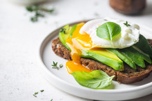 Healthy Breakfast Whole Wheat Toasted Bread With Avocado And Poached Egg Over White Background