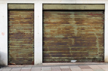 Old Closed Green Metal Rolling Shutters On An Old Building