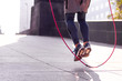 Unrecognizable athletic person jumping rope outdoors