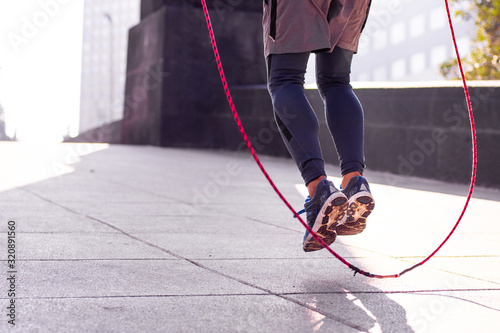 Unrecognizable athletic person jumping rope outdoors Tableau sur Toile