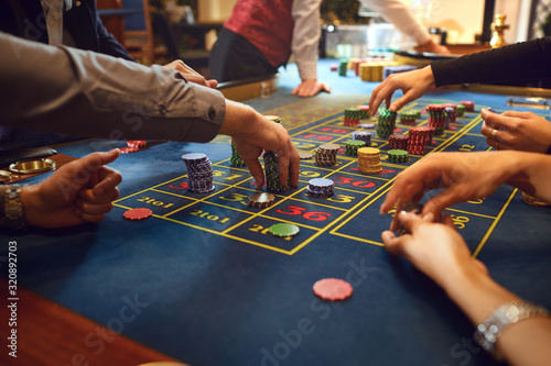 Fotomural Roulette table chips in a casino. Gamblers make bets in a casino.