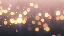 Bright Gold Bokeh Lights Abstract Background. Flying Golden Particles Or Dust. Vivid Lightning. Merry Christmas Design. Blurred Light Dots. Can Use As Cover, Banner, Postcard, Flyer.