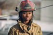 Women Firefighter with red helmet standing outside