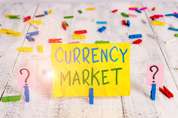 Conceptual hand writing showing Currency Market. Concept meaning over the counter market for the trading of currencies Crumbling sheet with paper clips placed on the wooden table