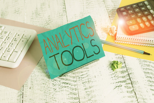 Handwriting text writing Analytics Tools. Conceptual photo pieces of web application analysis software used to monitor Notepaper standing on buffer wire between computer keyboard and math sheets