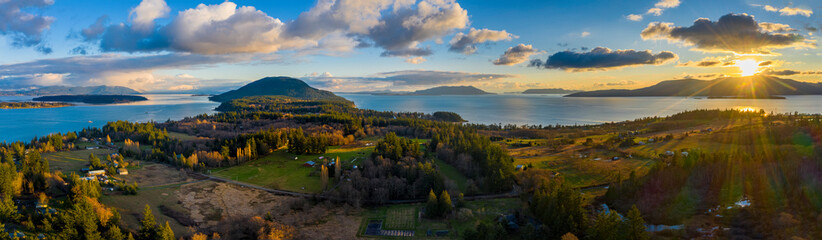 Aerial Panoramic View of Lummi island During a Glorious Sunset. Located in the Salish Sea, Orcas Island can be seen on the right with Bellingham Bay on the left. 