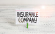 Writing note showing Insurance Company. Business concept for company that offers insurance policies to the public Green clothespin white wood background reminder office supply