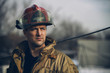 Male firerfighter with red helmet outside