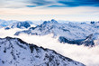 Beautiful Alps mountains with clouds at sunset. Winter landscape. Val Thorens, 3 Valleys, France.