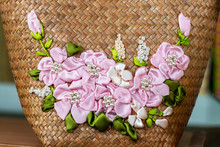 Artificial Roses Made From Pink Ribbons And Woven Bamboo Baskets.