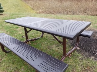 Empty metal picnic table with benches in outdoor public park