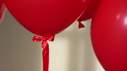 Wall Mural - red helium balloons on beige background