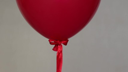 Wall Mural - red helium balloon on beige background