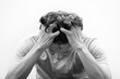 © chotiga - Asian man suffer headache hold hand head while feel pain headache stressful day or Aggression causes headache. Migraine concept.