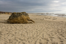 Large Rocky Outcropping On Sandy Beach 