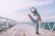 © Alena Ozerova - Hip hop dancer in fashion sportswear jumping and dancing in the street