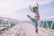 © Alena Ozerova - Hip hop dancer in fashion sportswear jumping and dancing in the street