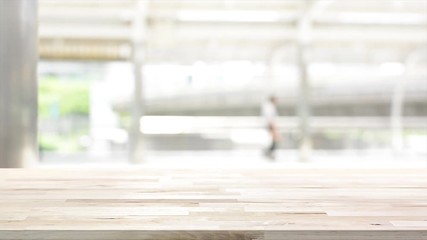 Wall Mural - Wood table top on white blur background of outdoor covered walkway in the city - can be used for display or montage your products