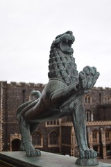 Wall Mural - Close up focus of bronze lion statues at the entrance of Norwich City Hall, Norfolk, England, UK. Norwich Guildhall out of focus in background.