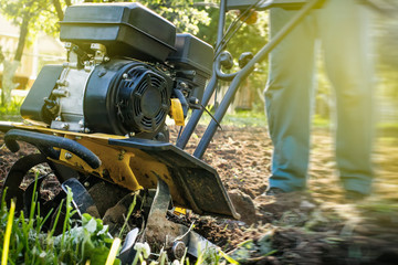 Grass and plowed soil nuggets during motor cultivator work