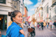 © Maridav - Tourist chinese young woman walking in city street shopping on travel vacation in fall autumn spring happy. Copenhagen city, Denmark.