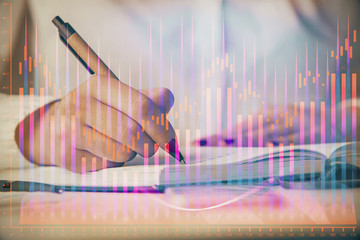 Multi exposure of woman's hands making notes with forex graph hologram. Concept stock market analysis.