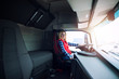 © littlewolf1989 - Professional female truck driver sitting in the truck. Transportation service.