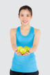 © NT_studio - Beautiful portrait young asian woman in sport clothing with satisfied and holding green apple isolated on white background, girl asia have shape and wellness, exercise for fit with health concept.