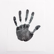© LIGHTFIELD STUDIOS - Top view of black print of hand on paper isolated on white, human rights concept