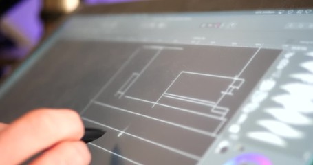 Wall Mural - an architect sketching and drafting out blueprints for a building project on a digital graphic table