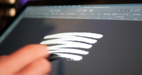 Wall Mural - a freelance artist and creative designer sketching and painting on a digital graphic tablet in a stu