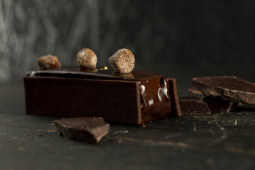 Chocolate cake between two buiscuits with streusel decoration