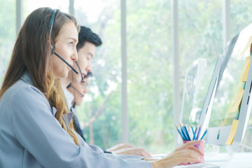 Business call center men and women team service 24 hour working on computer