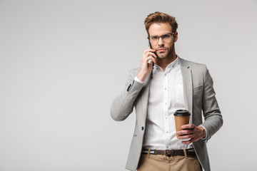 Canvas Print - Portrait of serious handsome man in eyeglasses talking on cellphone