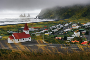 Wall Mural - Heavy clouds over the village of Vik i Myrdal in Iceland