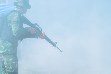 Wall Mural - silhouette of Soldier team backdrop of sunset sky.Soldier with machine gun patrolling 