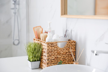 Wall Mural - Different toiletries and green plants on countertop in bathroom