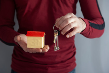 Wall Mural - man hand holding house model and key