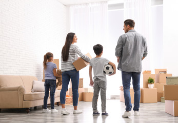 Wall Mural - Family in room with cardboard boxes on moving day