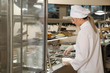 © New Africa - School canteen worker at serving line. Tasty food