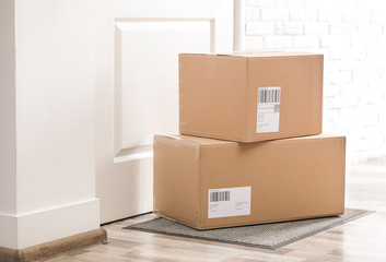 Poster - Parcels on rug near door. Delivery service