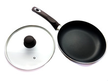 Black Pan And Lid Isolated On White Background. The Composition Of The Pan With A Lid. A Modern Frying Pan For The Cook. Glass Lid With Handle For The Pan.  