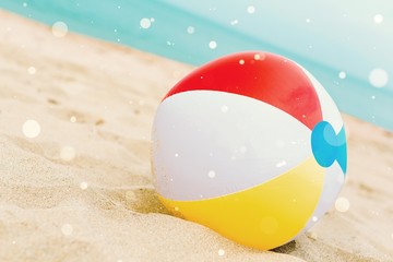 Canvas Print - Colorful beach ball in the beach sand