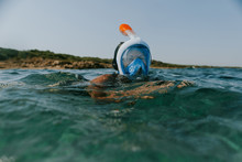 Woman Swimming At Water Surface Wearing Snorkel Mask. Woman Snorkelling In The Sea On Vacation.